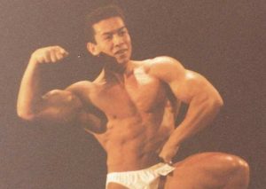 Bodybuilder Joe posing on stage in competition.
