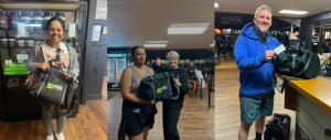 Gym members holding their duffle bags.
